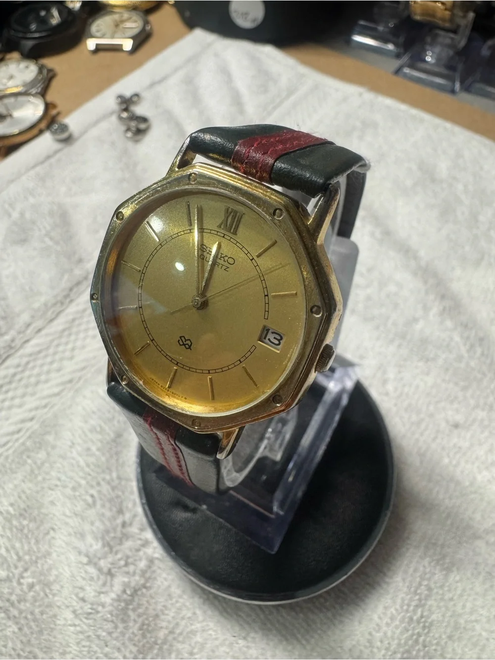 Seiko Gold Dial Watch with Black Strap and Red Stitch